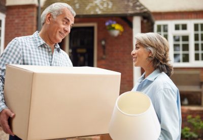 Mature,Couple,Carrying,Boxes,On,Moving,Day,In,Front,Of
